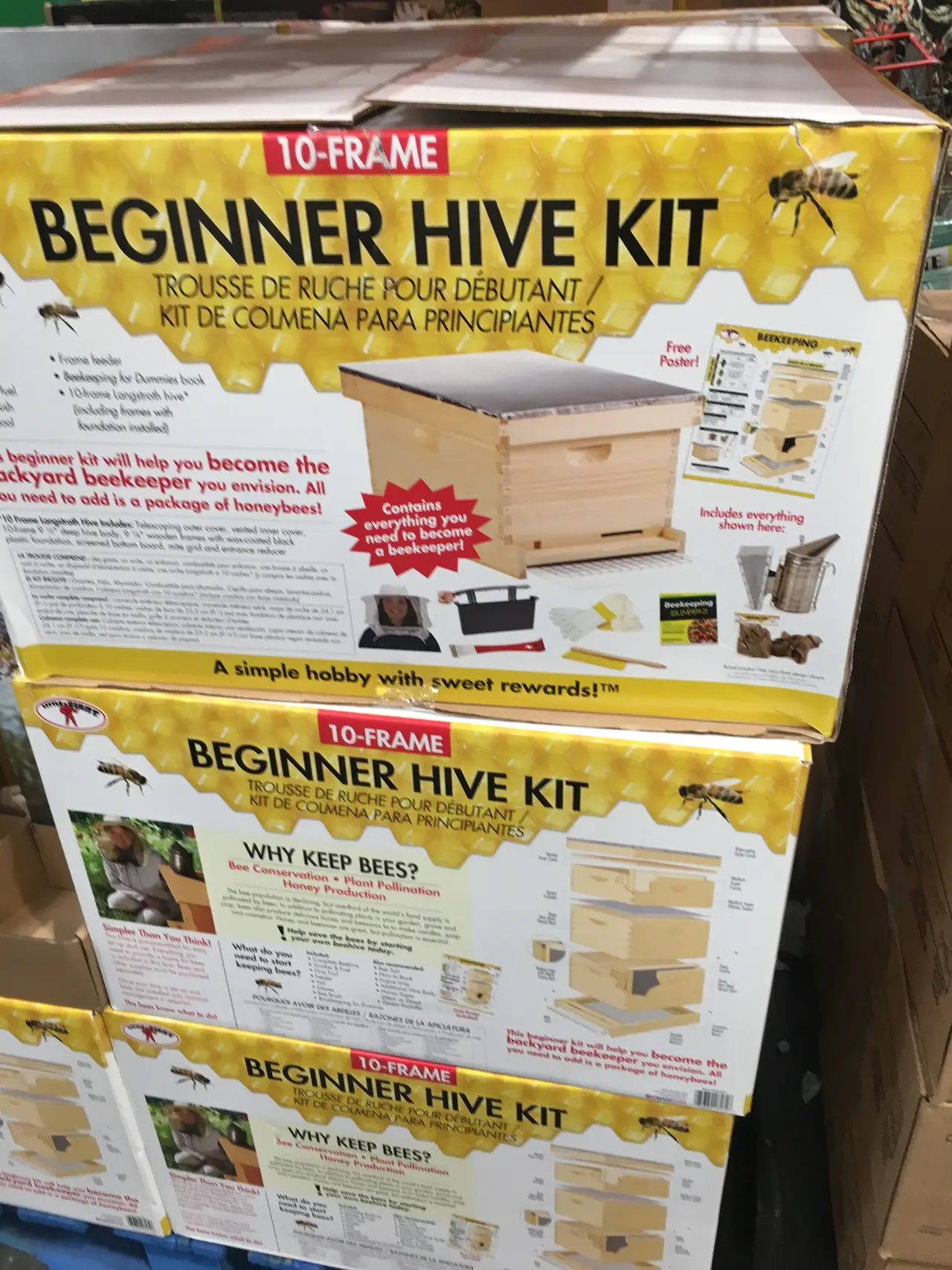 Boxes labeled beginner hive kit stacked in a store