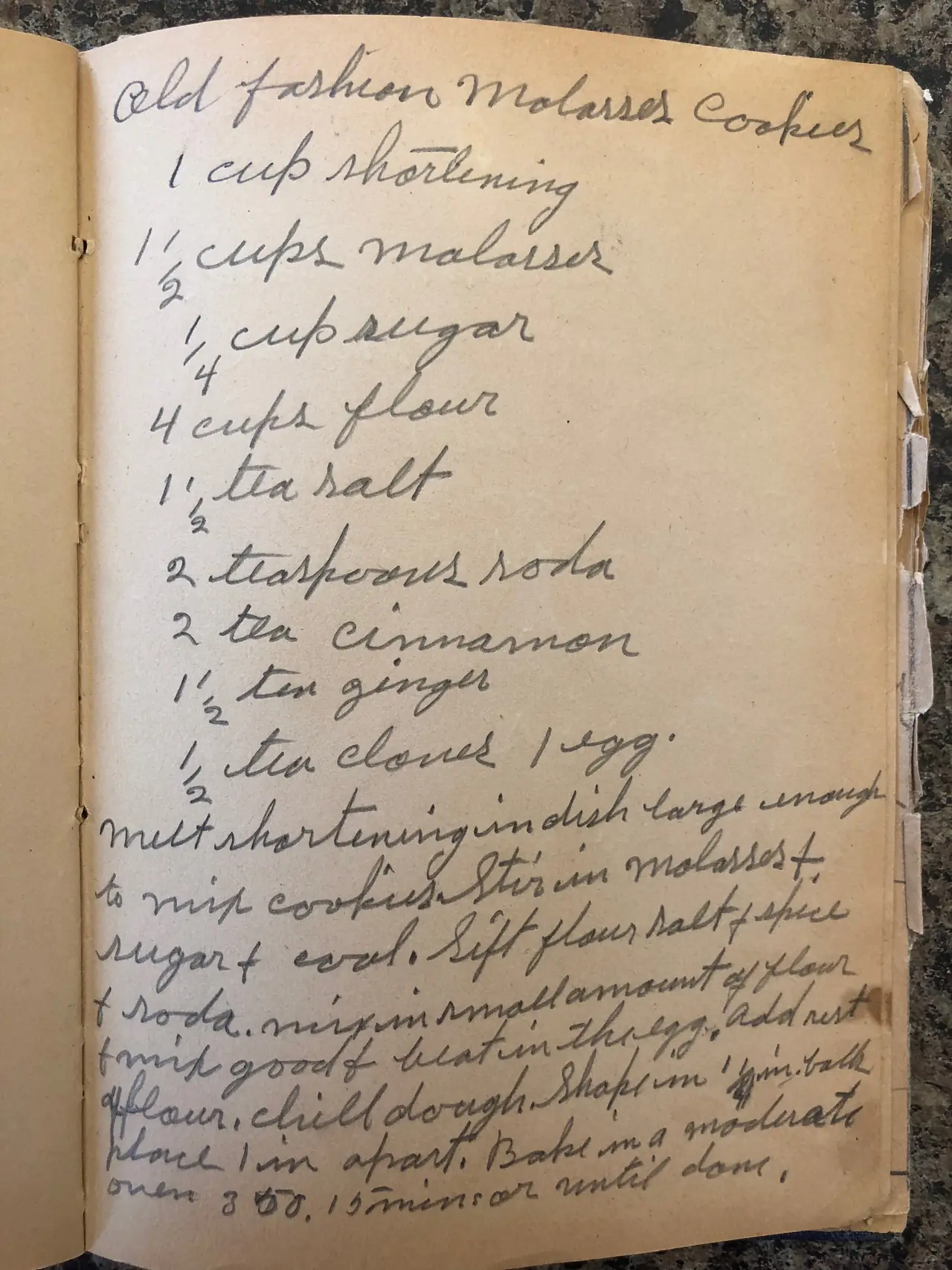 Open, worn recipe book showing a handwritten page titled Old Fashion Molasses Cookies