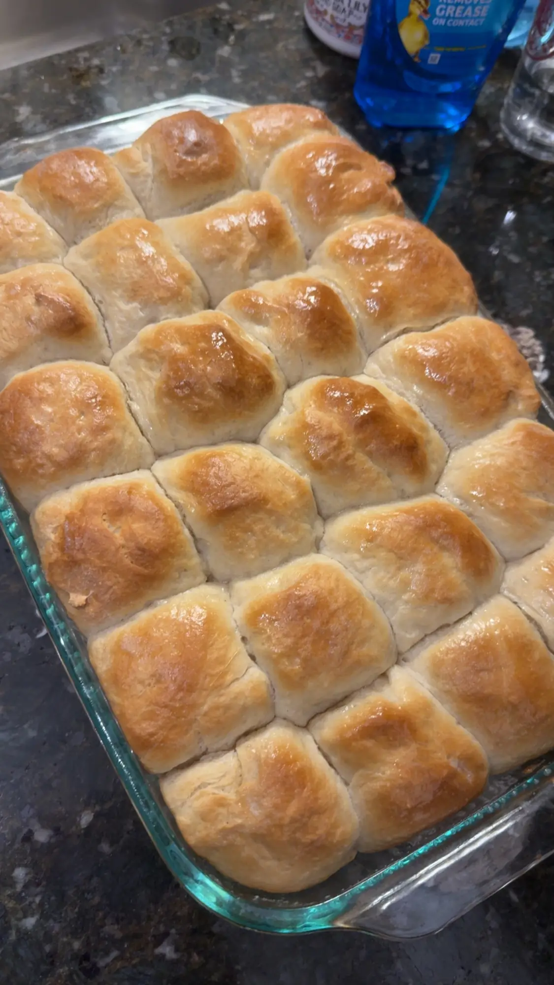 A glass pan of golden homemade pull-apart rolls