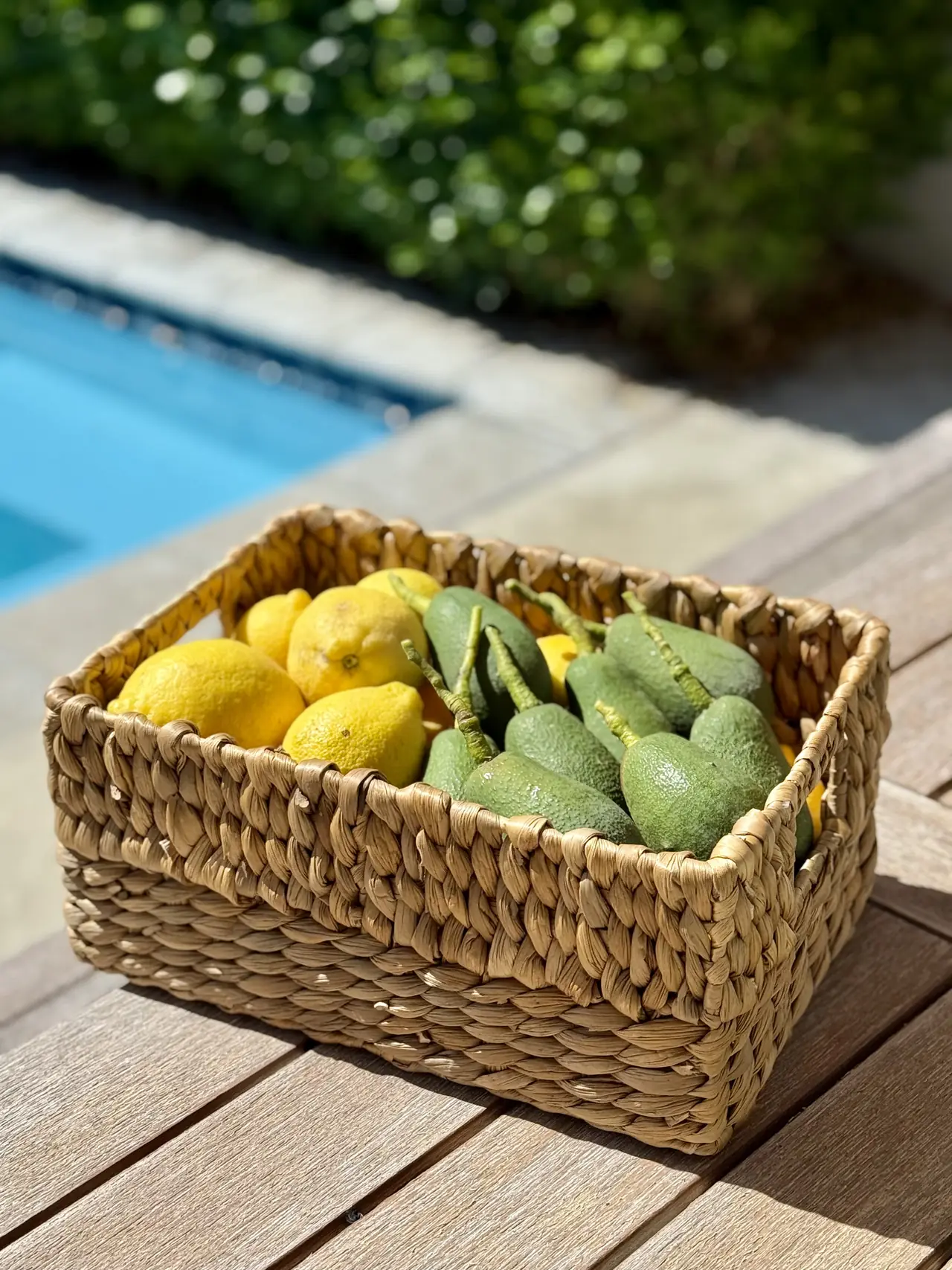 A woven basket of homegrown lemons and limes on a sunny table