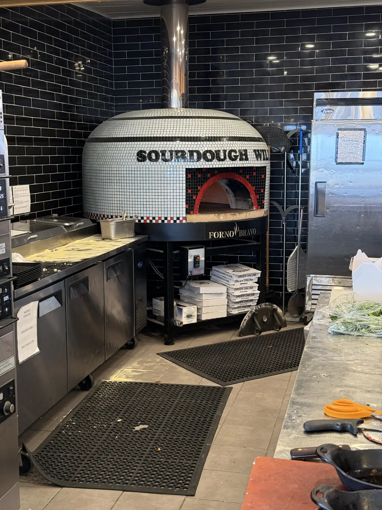 Large white tiled Sourdough Willy’s pizza oven inside the Kingston restaurant