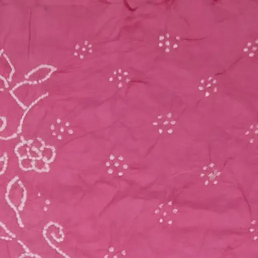 White dotted floral shapes on bright pink Bandhani fabric
